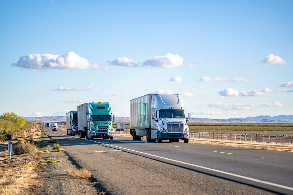 Industrial semi trucks transporting cargo on a highway